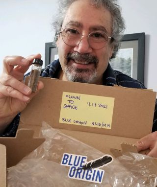 Huntsville Science Festival founder Joe Iacuzzo with the vial of flown-in-space dinosaur bones after their return by Blue Origin.