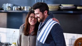 Woman and a man talking together in the kitchen to illustrate what you should do with sexual anxiety