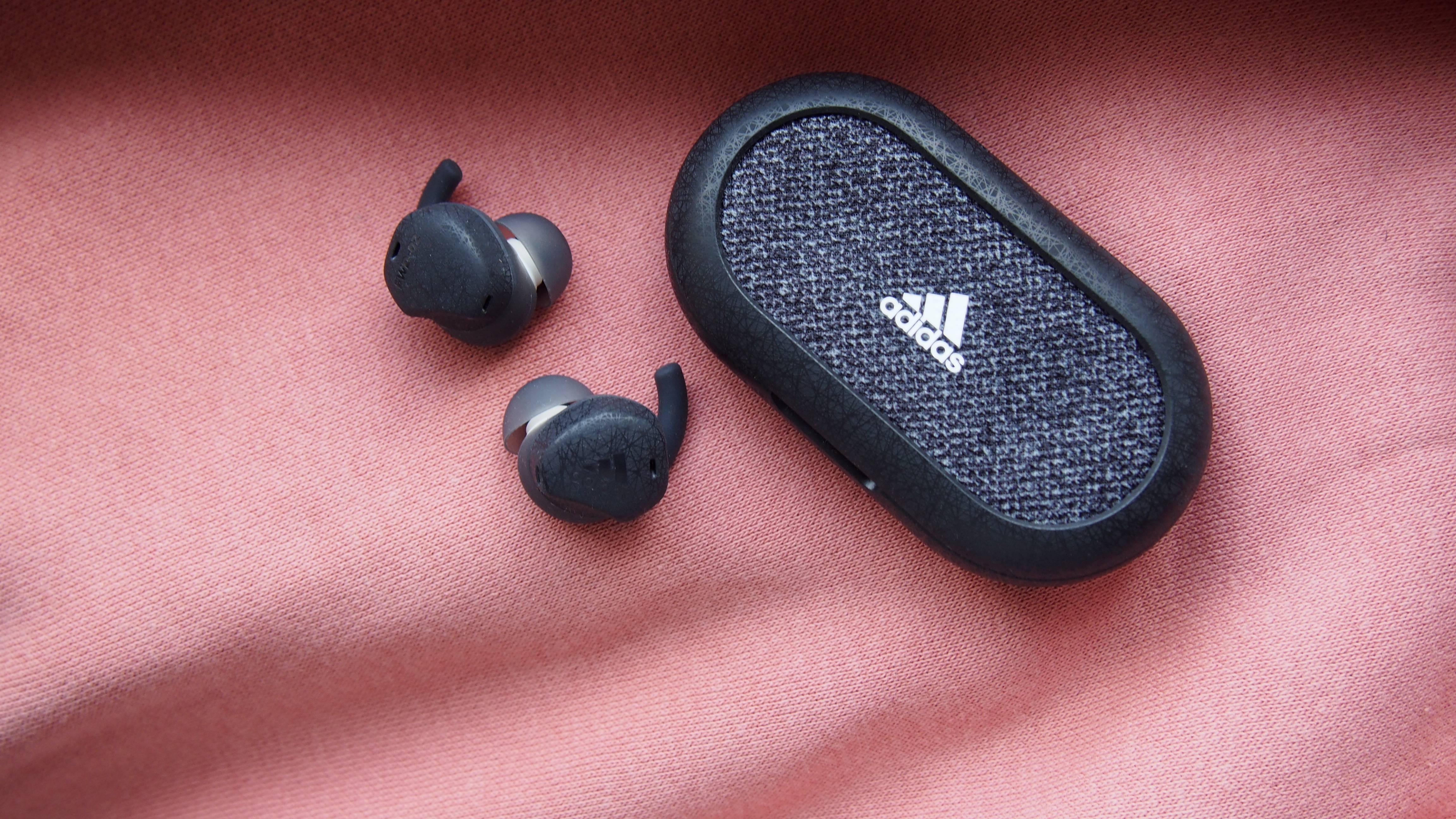 the adidas fwd-02 sport earbuds with their charging case