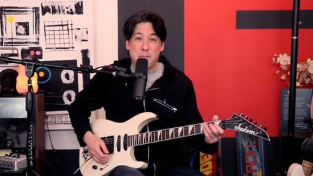 YouTuber and guitar educator Mike G. plays a white HSS Jackson Superstrat in this still from his home studio.