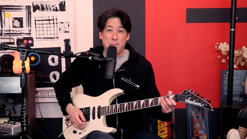 YouTuber and guitar educator Mike G. plays a white HSS Jackson Superstrat in this still from his home studio.