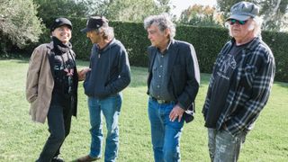 Crazy Horse regrouped for World Record. (from left) Nils Lofgren, Ralph Molina, Billy Talbot and Neil Young. OPENING PAGE: Lofgren performs at the 30th Annual Bridge School Benefit concert, Mountain View, California, October 22, 2016.