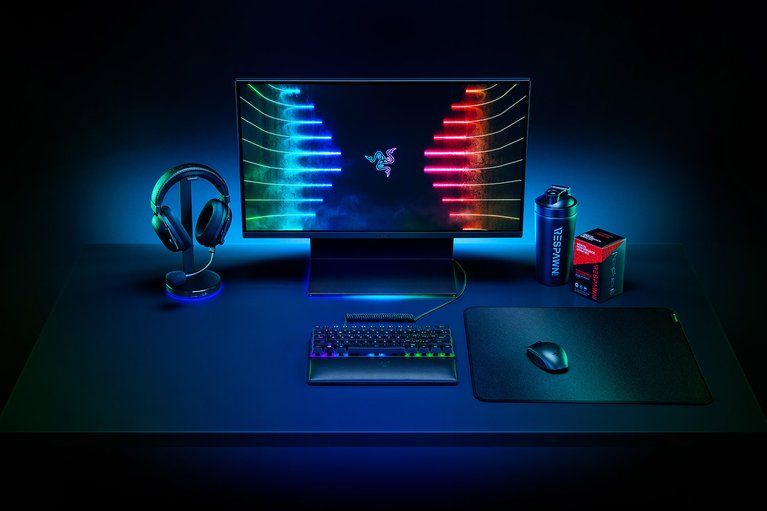 A Razer headset, keyboard, mouse and monitor on a desk.