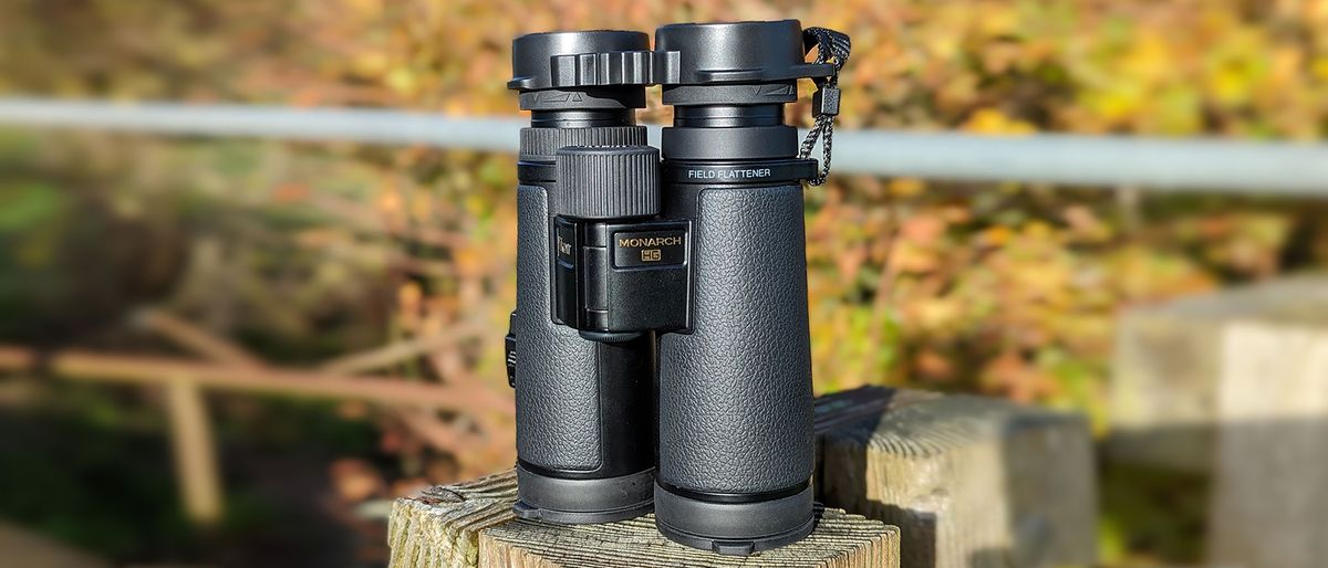 The binoculars in front of orange foliage