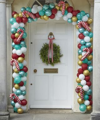 A balloon arch surrounding a festive front door