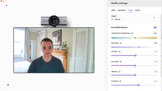 Screenshot of the Logitech MX Brio app showing a man at home on a video chat