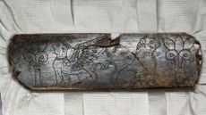 Carved elephant ivory on a white display from the Iron Age.