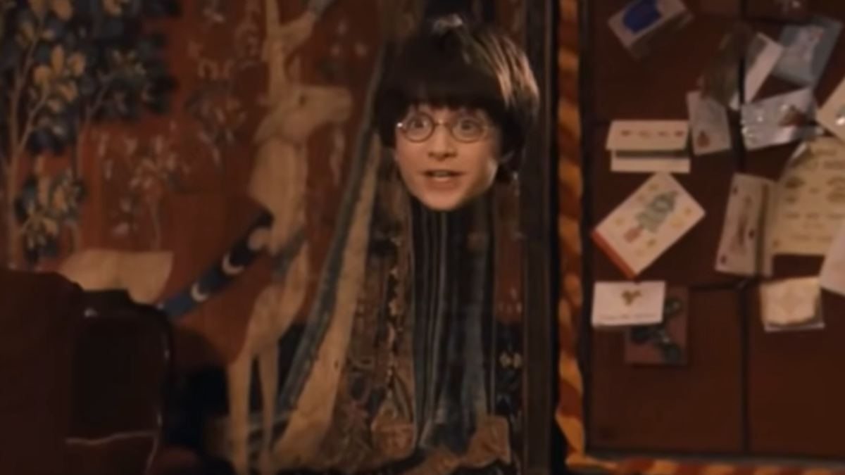 Harry using the Invisibility Cloak in Harry Potter and the Sorcerer&#039;s Stone.