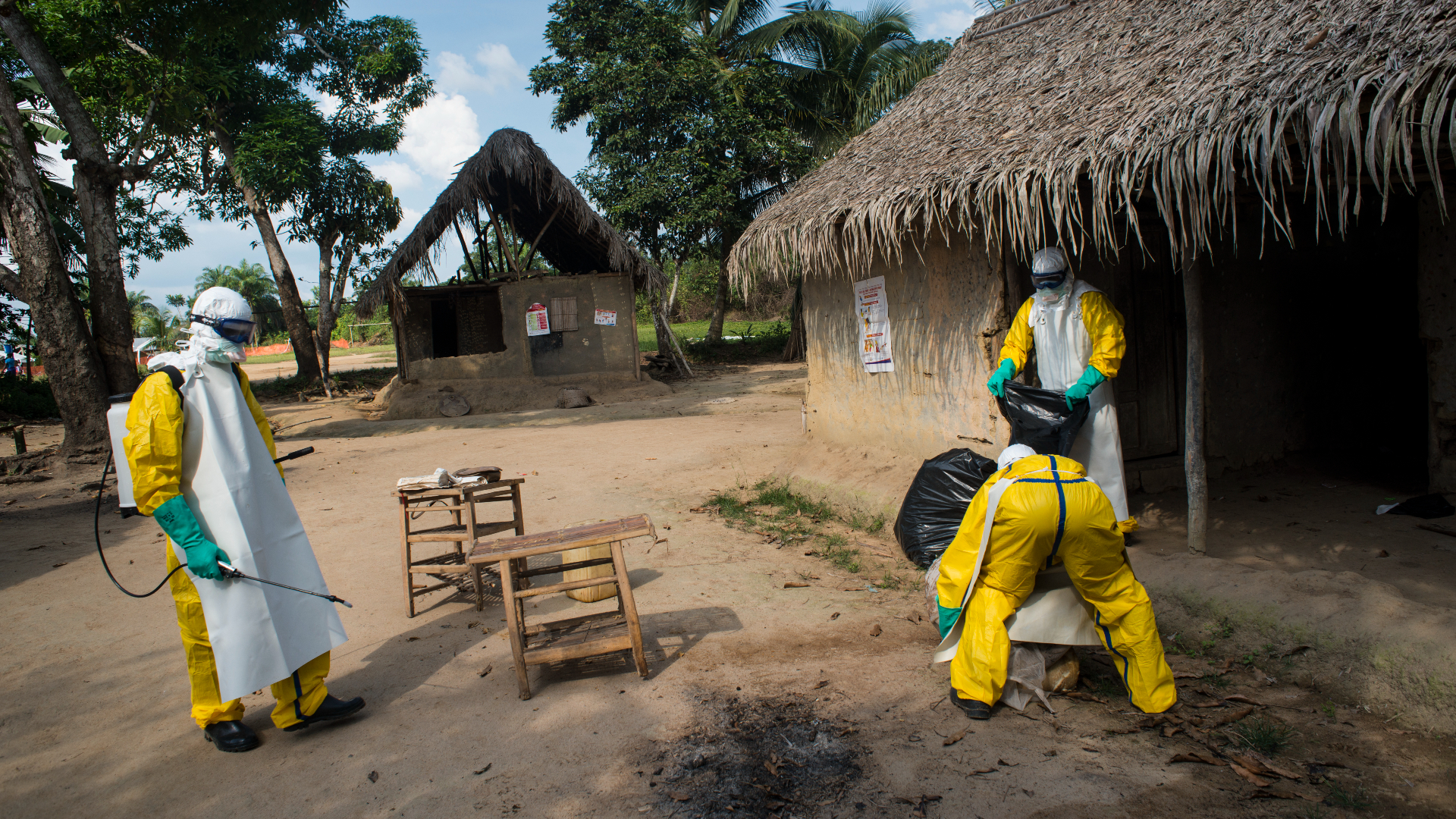 Medicins Sans Frontieres workers disinfect a home in Quewein, Liberia, where a person fell ill with Ebola on Thursday, December 11, 2014.