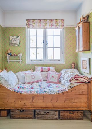 sleigh bed with gingham and patchwork and chintz fabrics and cushions