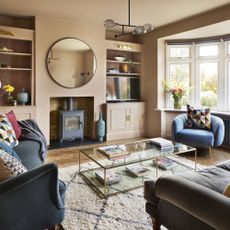 Pink living room with blue armchair and sofa