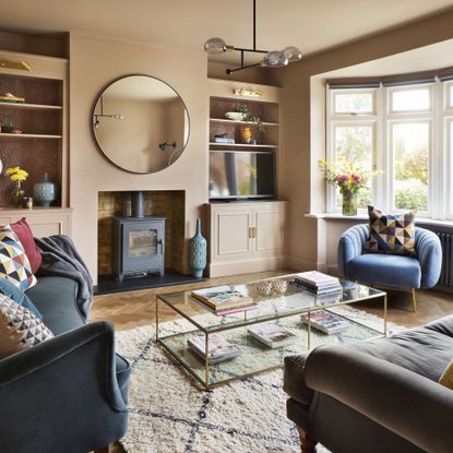 Pink living room with blue armchair and sofa