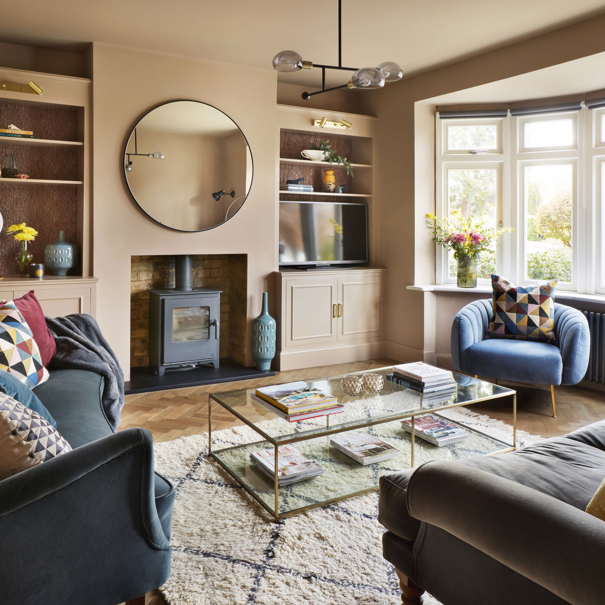 Pink living room with blue armchair and sofa