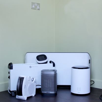 A group of the best electric heaters sat on a wooden floor
