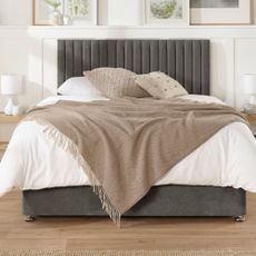 White divan bed and dark grey bed frame with neutral bedding