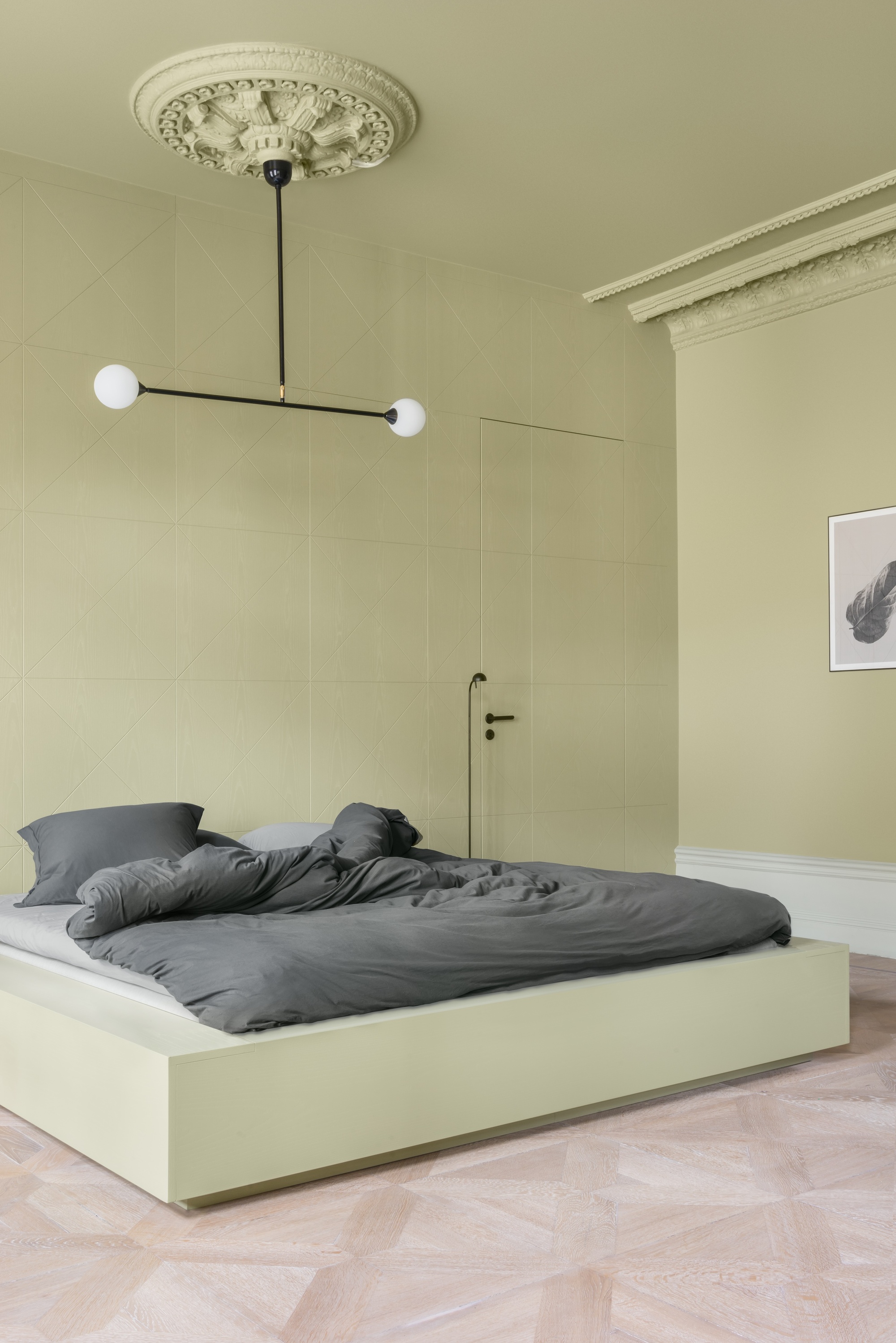 color drenched sage green bedroom with ceiling rose, modern pendant light, built-in bed with gray sheets, and parquetry floors