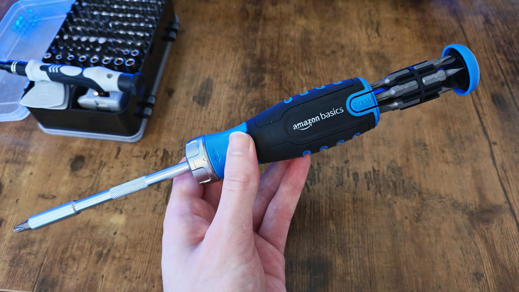 A reviewer holding the Amazon Basics magnetic screwdriver