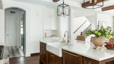 A large kitchen with cupboards painted in Simply White by Benjamin Moore