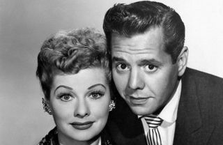 Lucille Ball and Desi Arnaz smirking in promo photo for I Love Lucy