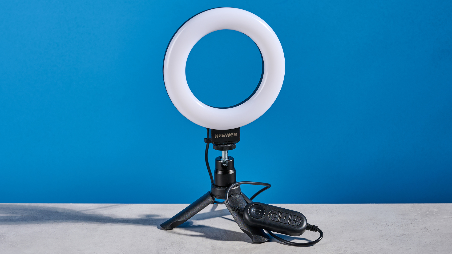 The Neewer Basics BR60 5" Ring Light photographed in front of a blue background.