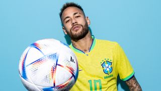 Neymar of the Brazil National Team poses with a football for the FIFA World Cup 2022 photo call in Qatar. 