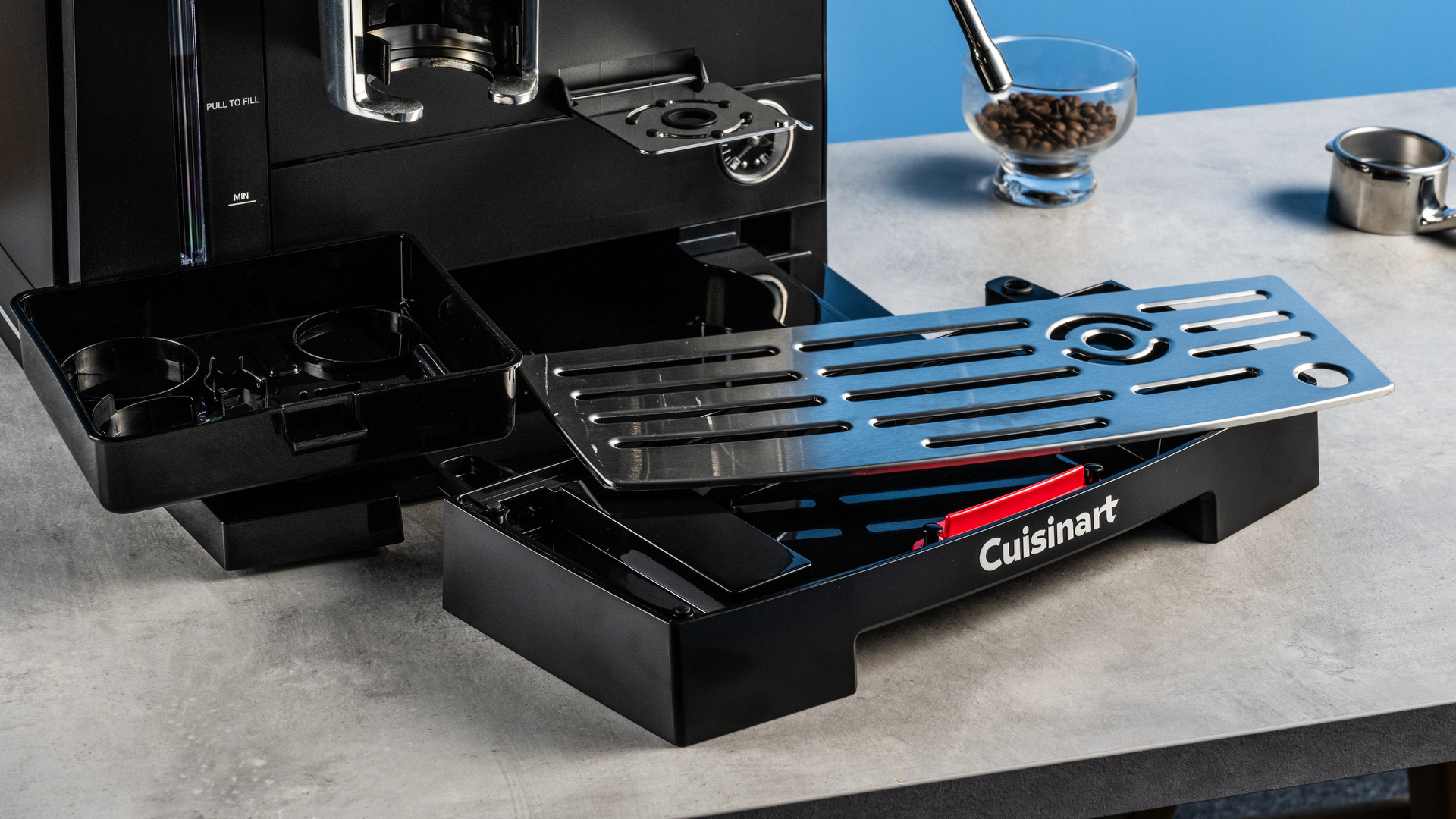 the cuisinart grind, tamp and brew espresso machine with built-in grinder photographed against a blue tom's guide background