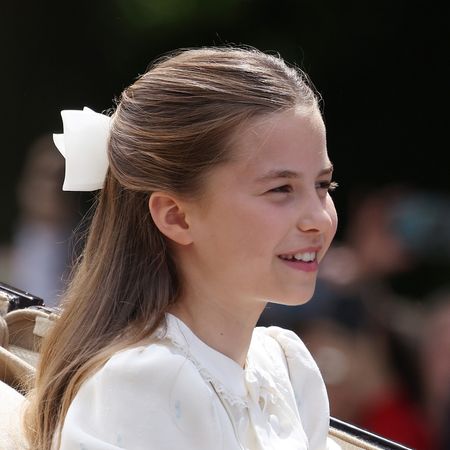 Princess Charlotte wears a white bow in her hair for Trooping the Colour 2026 and sits next to brother Prince George, who wears a suit