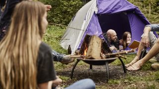 how to store firewood: family around campfire