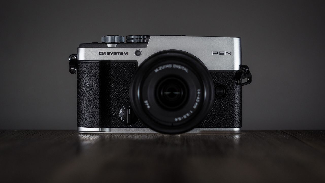 OM System OM-3 with the OM System M.Zuiko 14-42mm 3.5-5.6 III on a wooden surface