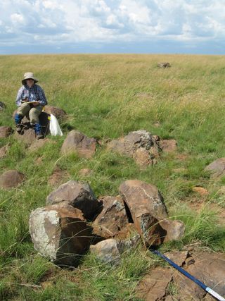 Lisa Cupelli at an outcrop of gabbronorite at the Vredefort impact crater.