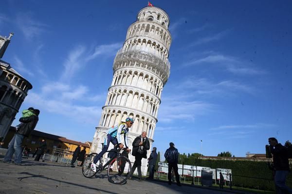 Alberto Contador rolls past the iconic Leaning Tower of Pisa.