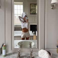 Creator @amaka.hamelijnck taking a mirror selfie with glowing skin 