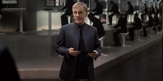Christoph Waltz holds a tablet, standing in the middle of his control room, in Spectre.