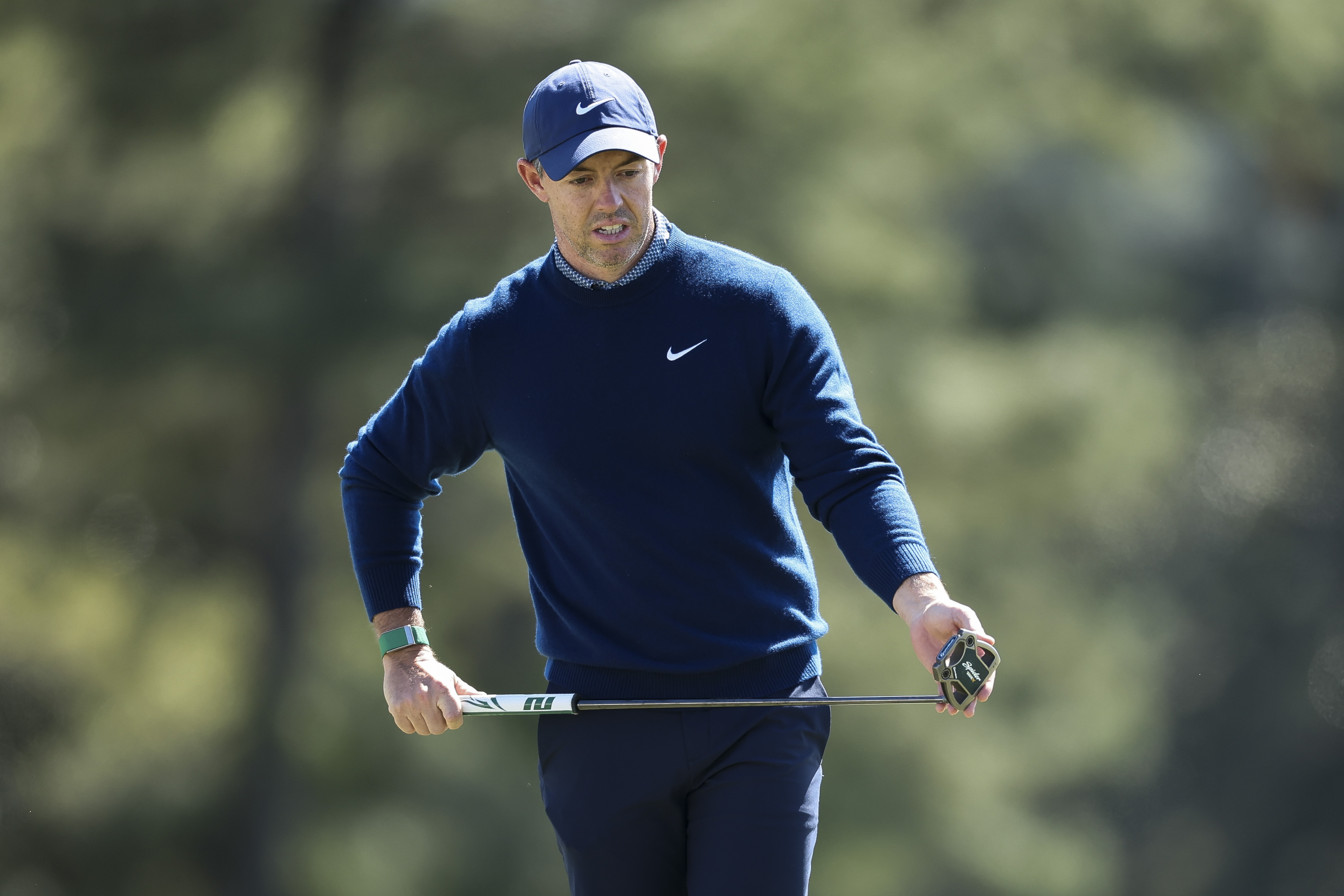 Rory McIlroy lines up a putt on the 18th green during the first round of the 2026 Masters Tournament at Augusta National Golf Club