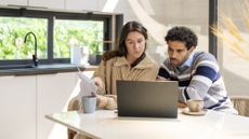 A couple work on financial planning at home. 