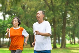 An older couple jogs together