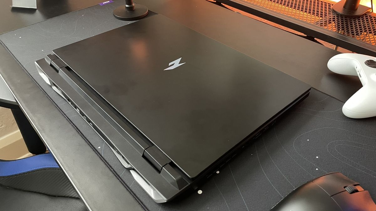The Acer Nitro 17 gaming laptop sitting on a black desk with the lid closed