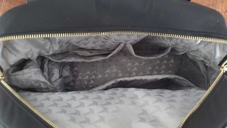 a closeup of a black overnight bag's insides