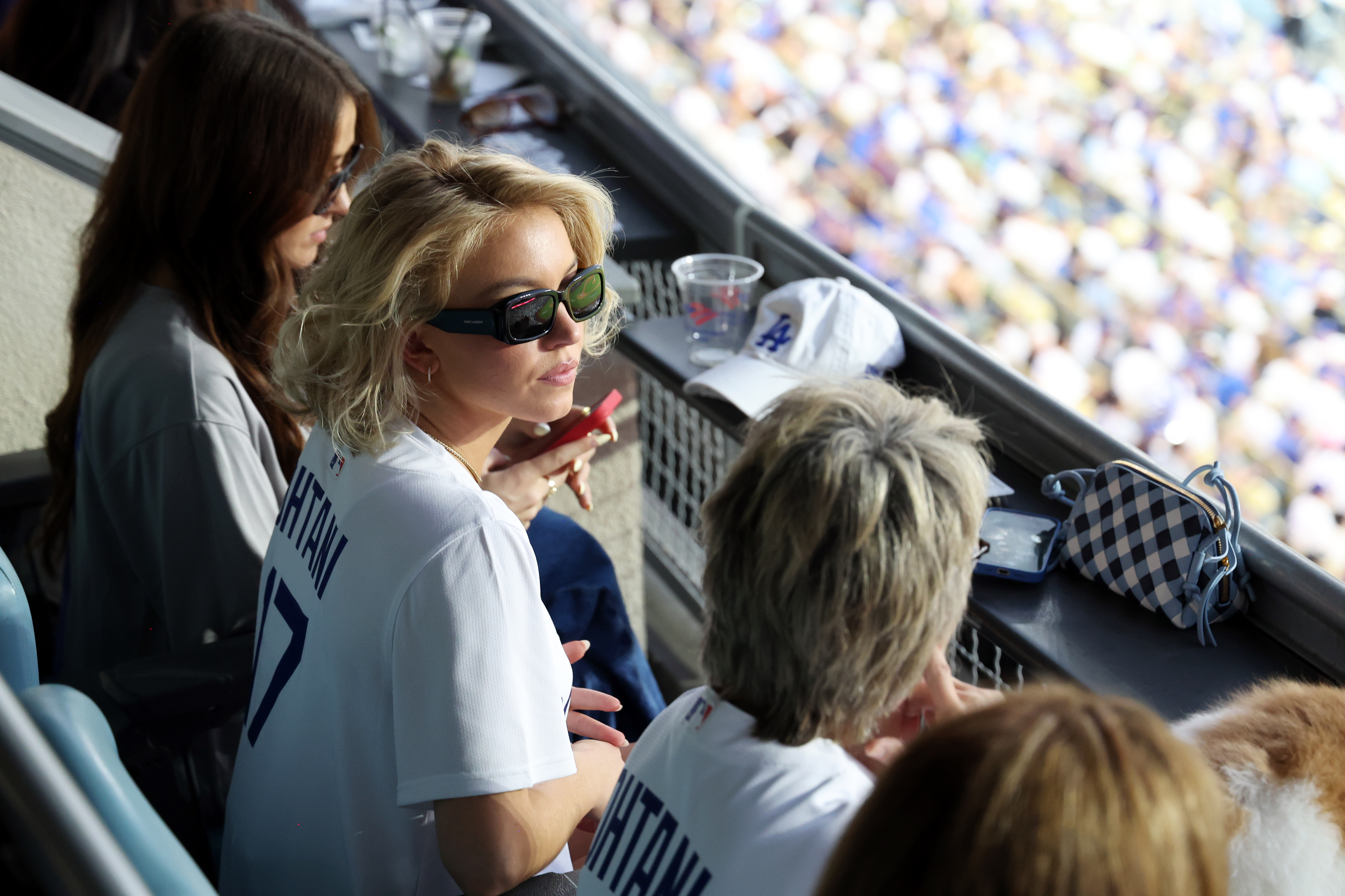 Sydney Sweeney paired her baseball game outfit with a gingham Bottega Veneta bag