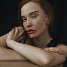 Woman with freckles, red hair and matte skin