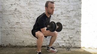 Man doing dumbbell concentration curls