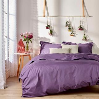 Puple bedding in a neutral bedroom