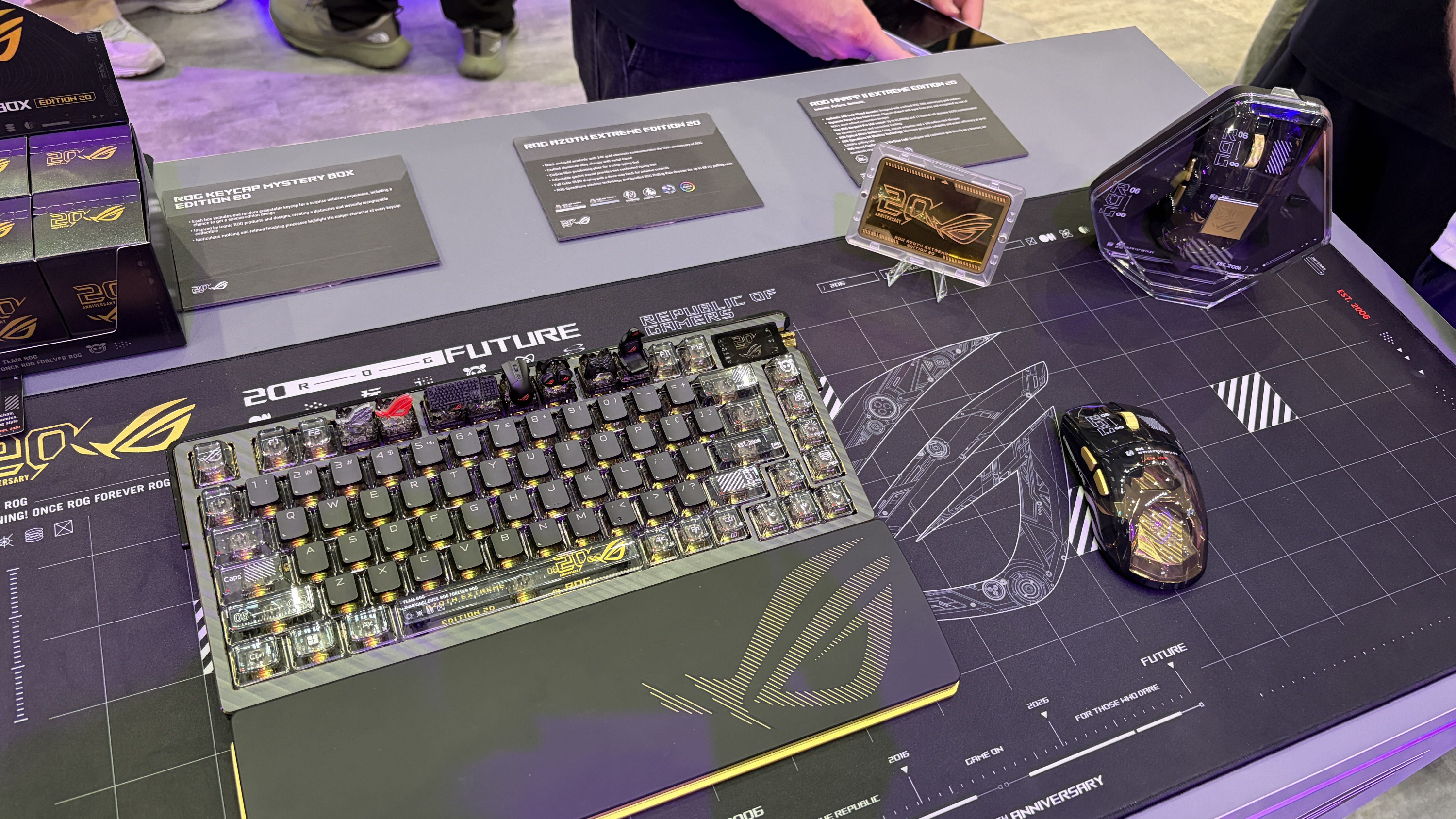 ROG-themed gaming keyboard and mouse on a display mat.