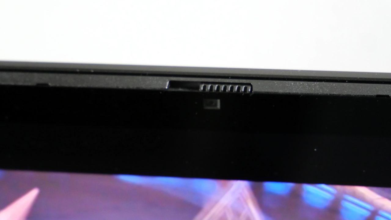 HP Omen Max 16 open against a white wall, highlighting its webcam and privacy shutter.