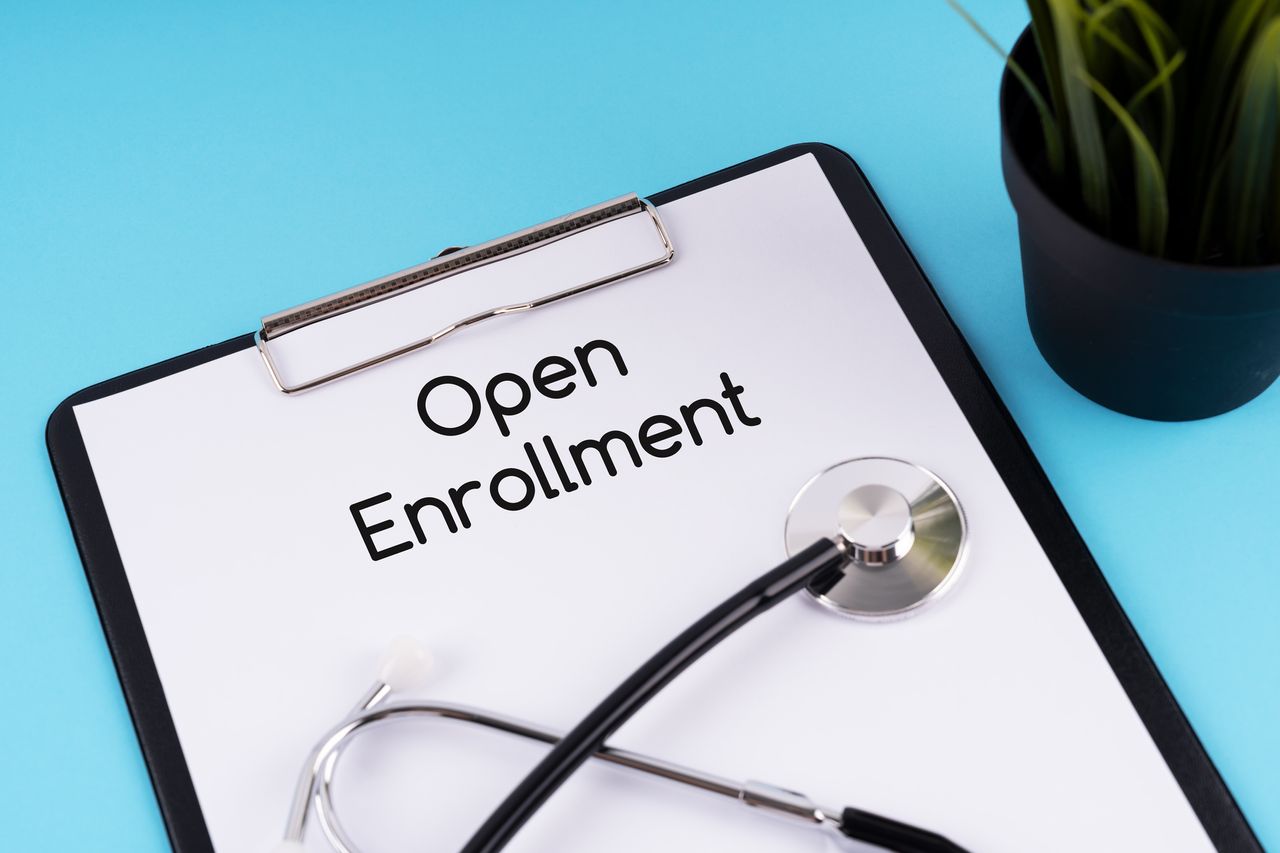 Stethoscope and clipboard with text Open Enrollment