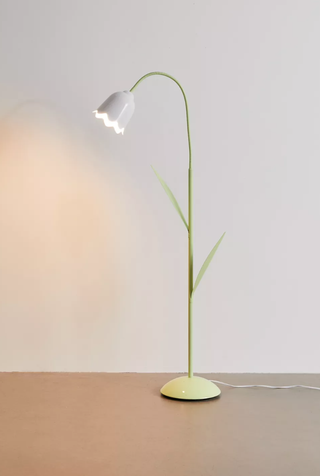 tulip-shaped floor lamp in a plain room