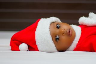 Image of a baby in a red and white Christmas hat