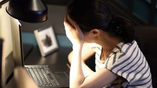 How to have more energy: Image shows tired woman with laptop