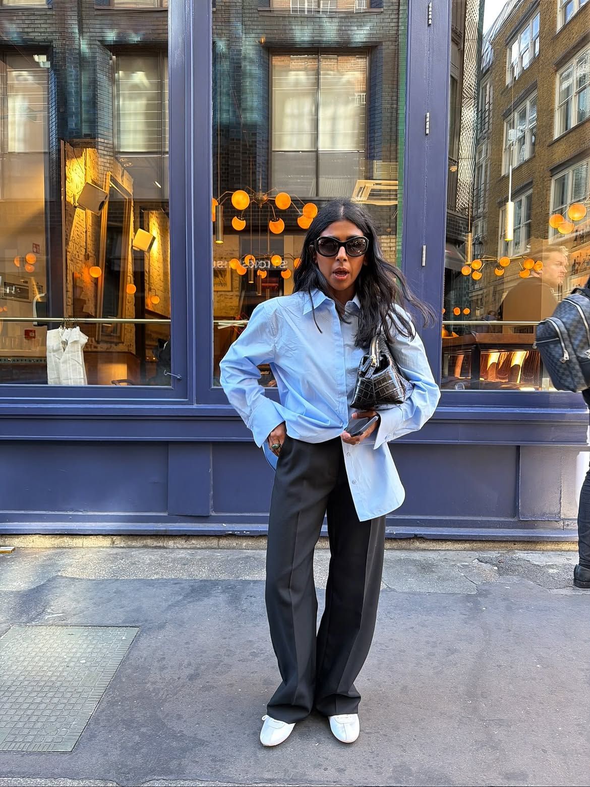 Button-down shirt and tailored trousers.