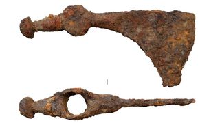 A rusty metal battle ax seen from two viewpoints.